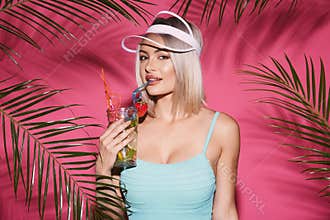 Pretty girl at pink studio background