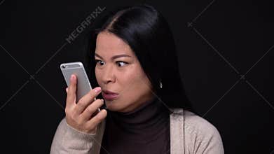 Angry woman screams at phone and tries to calm down