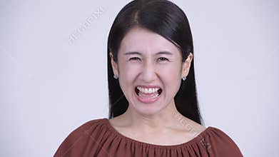 Face of angry Asian woman shouting and screaming
