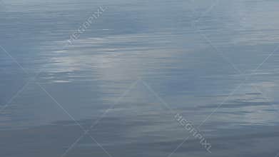 Clouds reflected on rippled water