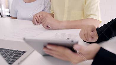 Asia smart female agent offers health insurance for elderly couples by document, tablet and laptop. Aged Asian couple consulting.