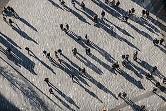People crowd walking on around city square view from the top.