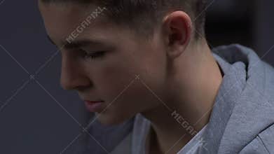 Teenager at psychiatrist office, listening to lecture on social behavior problem