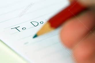 Person writing to do list