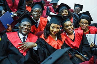 GRODNO, BELARUS - JUNE, 2018: Foreign african medical students in square academic graduation caps and black raincoats during