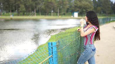 Woman relaxing next to a tranquil lake