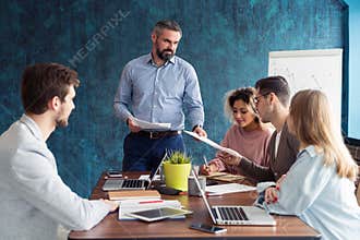 Human resource manager training people about company and future prospects. Group of businesspeople sitting in meeting