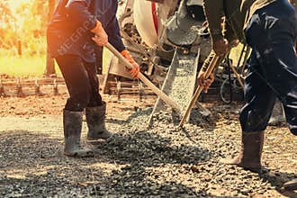 pouring concrete with worker mix cement at construction