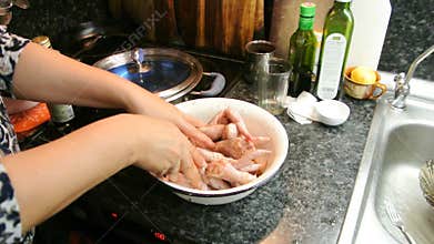 Female hands marinated chicken wings