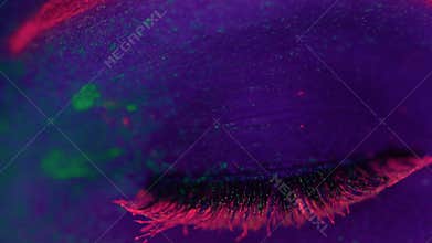 Woman with UV fluorescent makeup