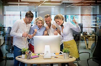 Happy business team celebrate success at work