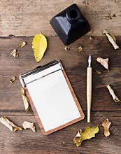 Fta lay clip board with lined paper, dip pen and ink on old wood