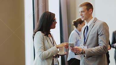 Couple with smartphone at business conference