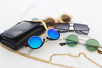 Different sunglasses and handbag