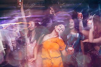 Dance party in night club in blurred motion