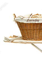 Laundry basket on ironing board against white