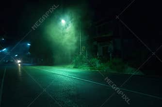 Smoke near street light on public road with old abandoned house background in Trang Thailand. Horror scene