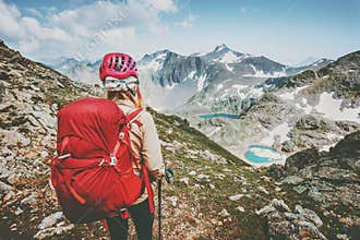 Adventurer tourist hiking in mountains with backpack Travel Lifestyle hiking adventure concept summer vacations outdoor exploring