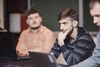 People in classroom using laptops