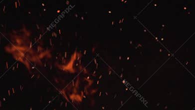 Ultra slow motion shot of fire flames and glowing ashes on black background