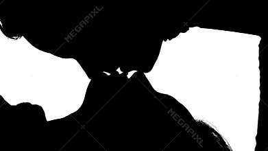 Girl is lying on the bed with her kissing guy. Silhouette. White background