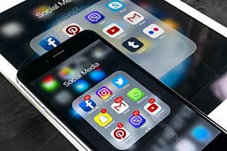Apple iPhone 7 and iPad pro with icons of social media facebook, instagram, twitter, snapchat application on screen. Smartphone