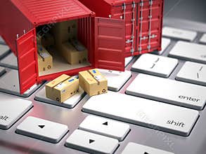 Red cargo freight shipping container on computer keyboard. Cargo shipping logistic concept