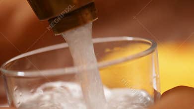 Filling a glass with water at the faucet