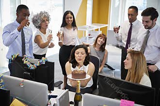 Colleagues gathered at woman�s desk to celebrate a birthday