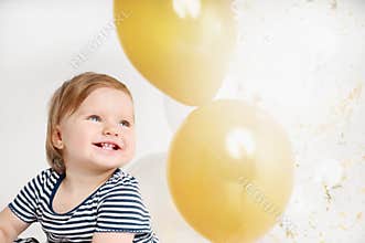 Happy and smiling one year old baby portrait with balloon background