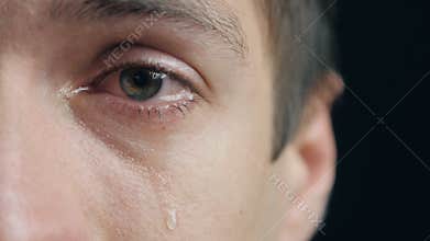 Shot of Crying man with tears in eye closeup