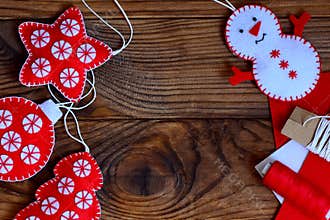 Easy Christmas crafts for adults or kids to make. Felt star, Christmas tree, snowman and ball on a brown wooden background