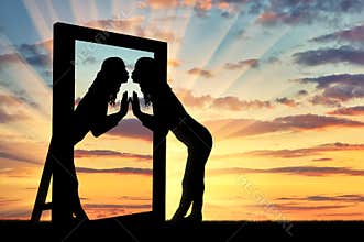 Woman is kissing her reflection in the mirror