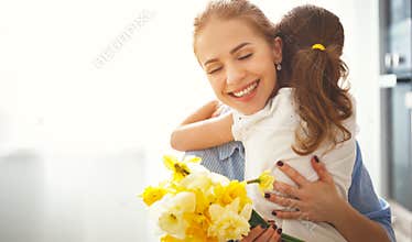 Happy mother`s day! child daughter gives mother a bouquet of f