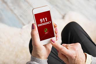 Old person dialing emergency number 911 on phone
