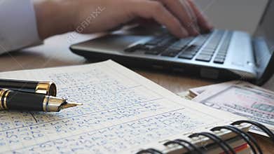 Man in an office typing on a keyboard. Accounting.