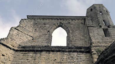 Gothic stone window with arched arch. Gothic cathedral without roof.