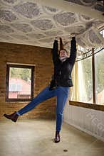 BUKOVEL, IVANO FRANKIVSKAYA OBLAST, UKRAINE- April 2, 2018: Unusual foreshortening of the girl holding the bed