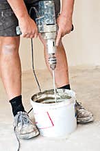Worker making glue for tiles