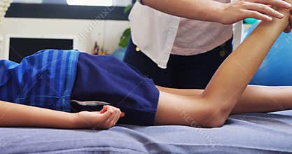 Physiotherapist giving physical therapy to the boy 4k