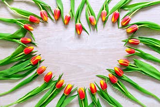 Heart from Red Tulips Flowers on rustic table for March 8, International Womens Day, Birthday , Valentines Day or Mothers day - Cl