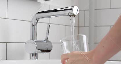 Filling glass of mains water, drinking water