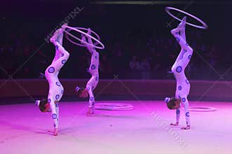 Circus acrobats in bright ultraviolet rays