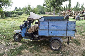 Scooter ant. Old Soviet motor scooter on three wheels with a cart