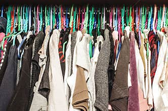 Fashion clothes on clothing rack - bright colorful closet.