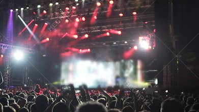 Energetic crowd of fans jumping at music festival, impressed by rock star show