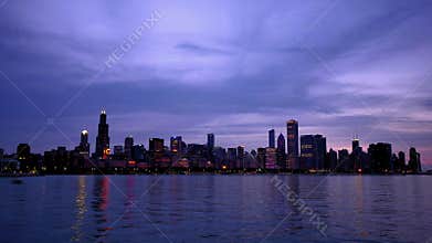 Chicago skyline reflected on the lake at sunset time lapse