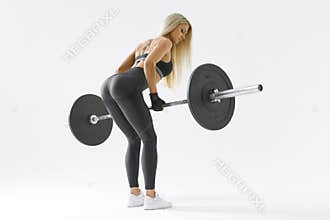 Fit young woman lifting barbell