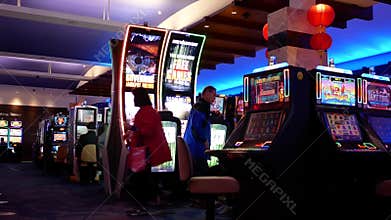 Motion of people playing slot machine inside Casino