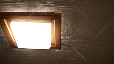 Panning to bathroom fan light in rustic bathroom